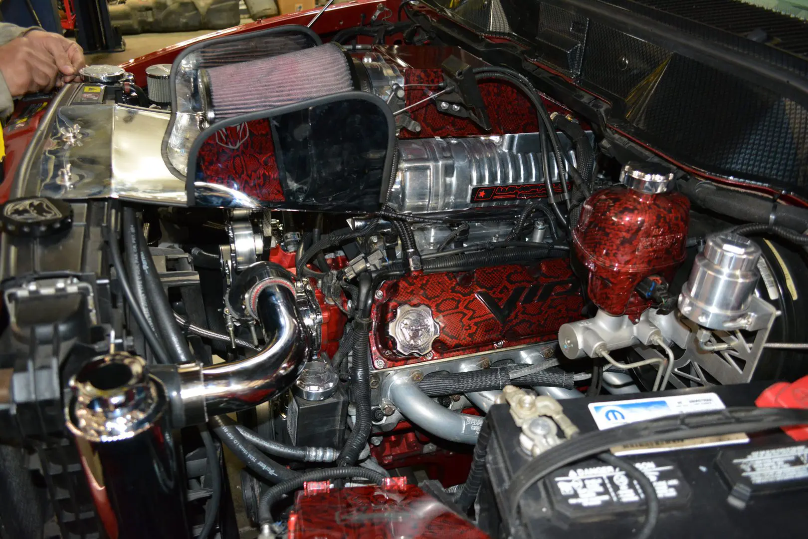 A red motorcycle engine with the cover removed.