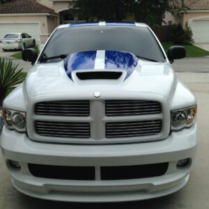 A white truck with blue and white stripes on the hood.