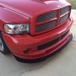 A red truck parked in the driveway of a house.