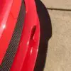 A close up of the side of a red car.