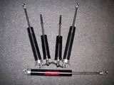 A set of four telescopic handles and one large handle.