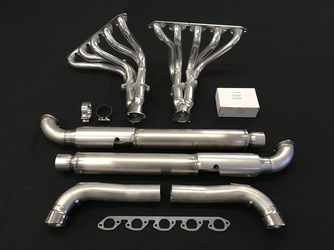 A set of exhaust pipes and headers on top of a table.