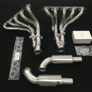 A set of exhaust pipes and headers are laid out on the table.