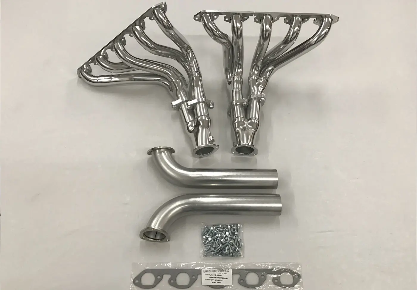 A set of exhaust pipes and hardware for a car.