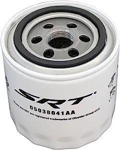 A white and black oil filter is sitting on the floor.