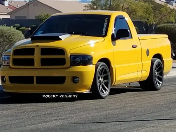 A yellow truck is parked on the street.