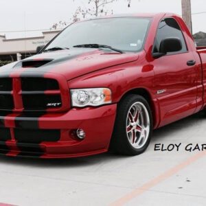 A red truck with black stripes on the hood