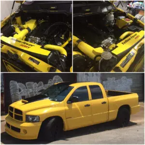 A yellow truck with a lot of engine parts