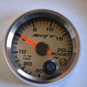 A white and silver gauge with orange needle.