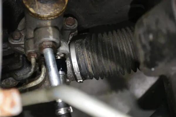 A close up of the steering wheel on an old car