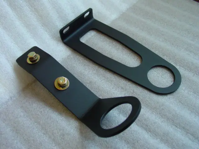 A pair of black metal brackets with one holding the other.