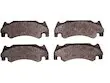 A set of four brake pads for a car.