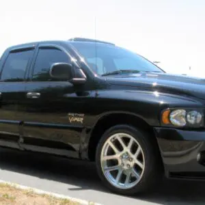 A black truck is parked on the side of the road.