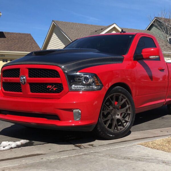 A red truck parked on the side of a road.