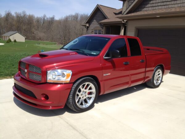 A red truck parked in front of a house.