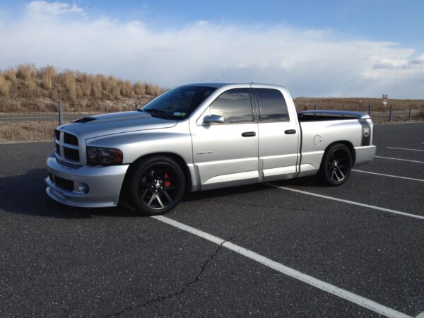 A silver truck parked in the parking lot.