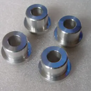 A set of four metal wheels with blue rims.