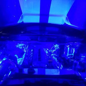 A view of the inside of an airplane with blue lights.