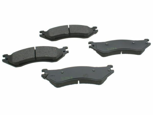 A set of four brake pads that are on the ground.