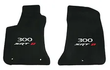 A pair of black floor mats with the word " 3 0 0 srt ".