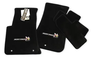 A set of black floor mats with the logo for sport pack.