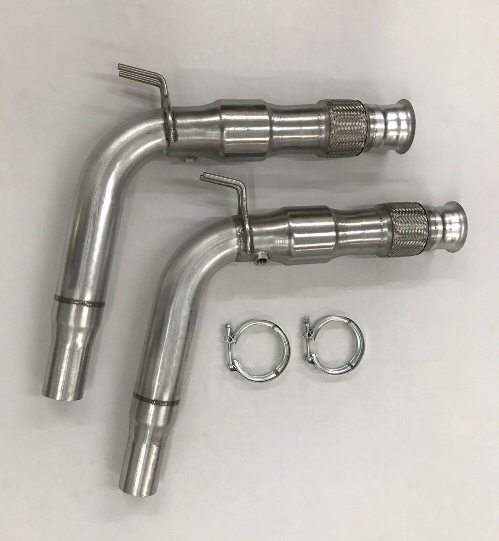 A pair of stainless steel exhaust pipes with clamps.
