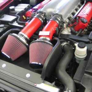 A close up of two red air intake on a car