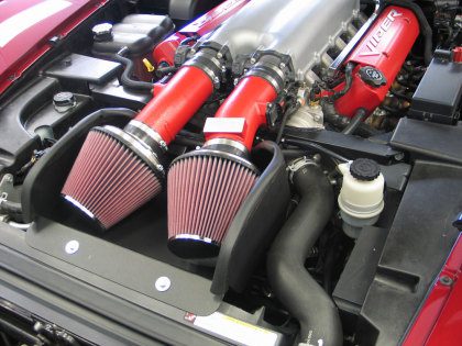 A close up of two red air intake on a car