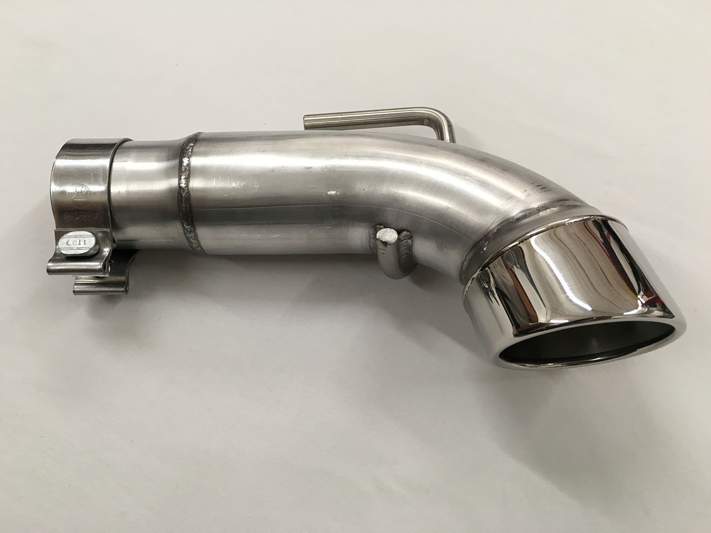 A chrome exhaust pipe on top of a white table.