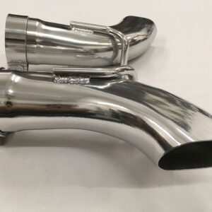 A chrome exhaust pipe sitting on top of a white table.