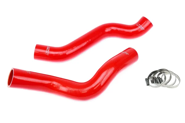 A pair of red hoses are laying on the ground.