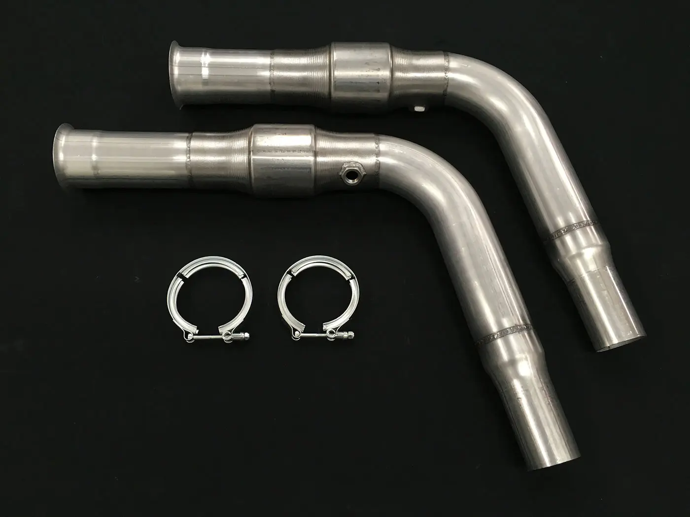 A pair of exhaust pipes with two clamps attached.