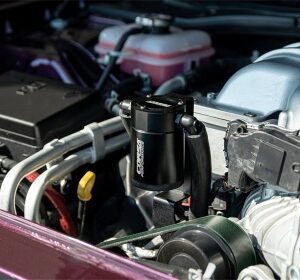 A car engine with the hood open and the engine bay.