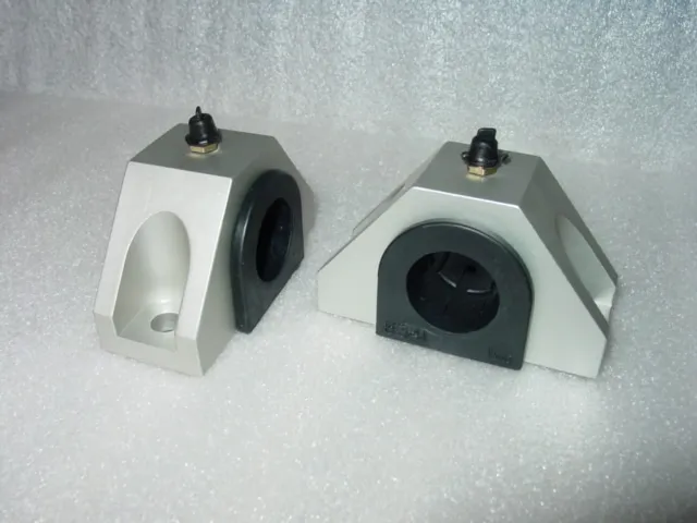 A pair of white and black rubber clamps.