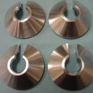 A set of four copper discs with one hole in the middle.