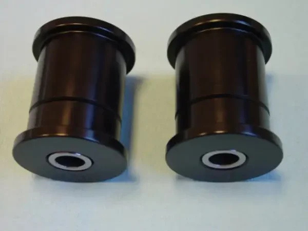 A pair of black bushings sitting on top of a table.