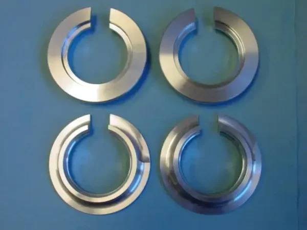 A set of four metal rings on top of a blue surface.