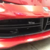 A red car with its front end broken down.