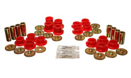 A set of red bushings and bushes are sitting on top of a table.