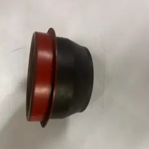 A black and red rubber cap sitting on top of a white surface.