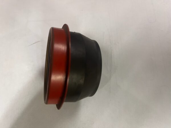 A black and red rubber cap sitting on top of a white surface.