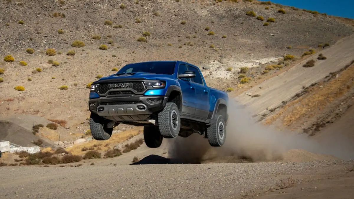 A blue truck is flying through the air